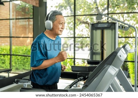 Senior old man runner exercise indoor gym. fitness man jogging wearing sportswear. Mature athlete man in sportswear Workout running on the treadmill.