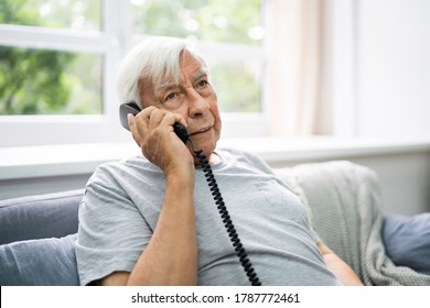 Senior Old Man Talking On Landline Telephone