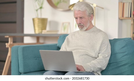 Senior Old Man Using Laptop At Home