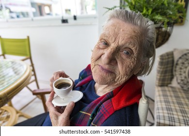 Senior Old Turkish Woman Smiling To The Camera And Drinking Turkish Coffee