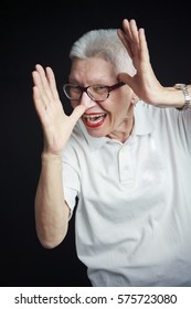 Senior Old Woman, A Grandma, Making A Grimace With Her Face And Hands, Making A Silly Face, Being Childish