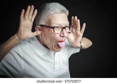 Senior Old Woman, A Grandma, Sticking Her Tongue Out, Making A Silly Face, Being Childish