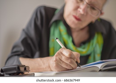 Senior Old Woman Writing Down Letters On A Piece Of Paper, Recor