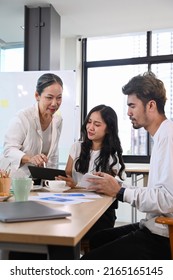 Senior Older Female Executive Ceo And Young Employee Discuss Corporate Project Together At Briefing