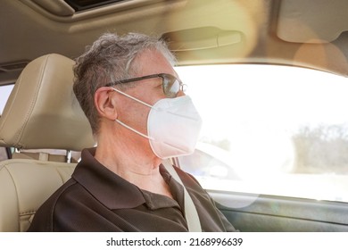 Senior Older Man Driving While Wearing A Face Mask