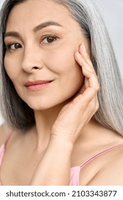 Senior Older Middle Aged Asian Woman's Face With Perfect Skin. Older Mature Lady Touching Face. Advertising Of Dermatology Cosmetology Salon Spa Procedures Skincare. Vertical Portrait.