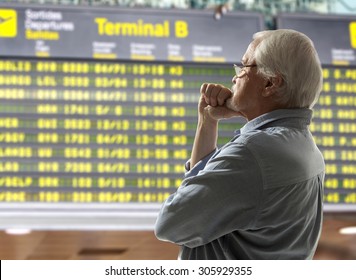 Senior On A Background Of Departure Board At Airport