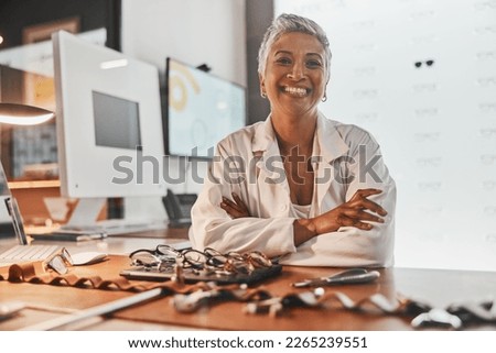 Senior optometrist woman, portrait and office with glasses, smile or frame design planning at desk. Happy optician, spectacle designer and excited face in workplace for pride, small business and goal