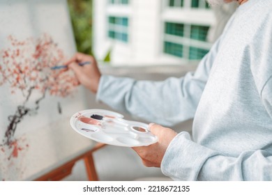 Senior painting on canvas, old man drawing in backyard garden. Senior mature artist holding color paint drawing on white paper. Elderly activitie. happy elderly. lifestyle and retirement concept. - Powered by Shutterstock