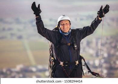 Senior Paraglider On The Ground Prepairs To Fly.