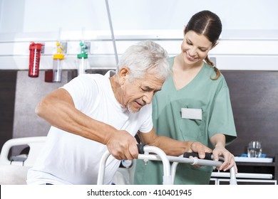 Senior Patient Being Assisted By Female Nurse In Using Walker