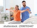 Senior patient exercising under physiotherapist supervision in rehabilitation center