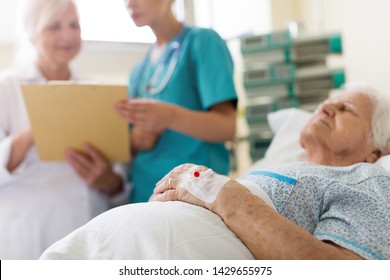 Senior Patient In Hospital Bed