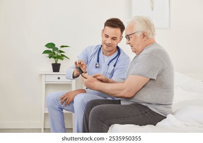 Senior patient learning to use a health care app on a mobile phone. Chubby overweight old man and a friendly young doctor in a uniform with a stethoscope sitting on a bed using a modern phone together - Powered by Shutterstock