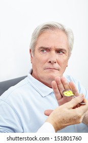 Senior Patient Refusing To Take Medicine On A Spoon