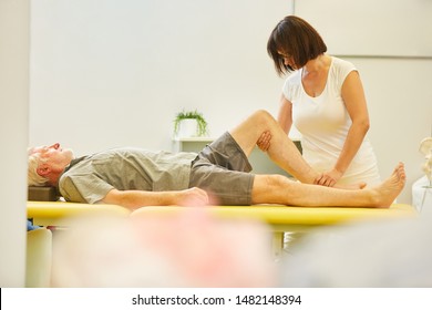 Senior As A Patient In Rehab Gets Physiotherapy On The Knee Joint For Pain Relief