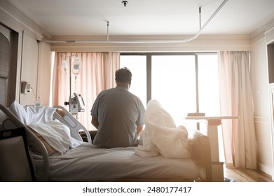 Senior Patient Siting Up Over the Edge of the Bed In the Hospital - Powered by Shutterstock