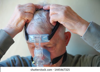 Senior patient with sleep apnea treatment machine head gear