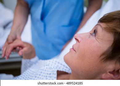 Senior Patient Talking To A Nurse In Hospital Room