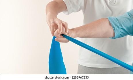 Senior patient undergoing rehabilitation with a blue stretch band ( with photographic effect) - Powered by Shutterstock