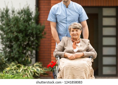 Senior pensioner on wheelchair in the garden of nursing home