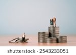 Senior pensioner standing on heap coins stacking and old man sitting on coin for rich and poor retirement concept.