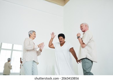 Senior People Dancing To Music During Lesson In Dance Studio