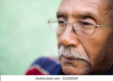 Senior people and feelings, portrait of sad old black man with glasses and mustache. Copy space