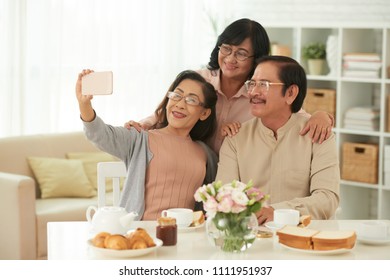 Senior People Making Selfie Portrait While Drinking Tea At Home