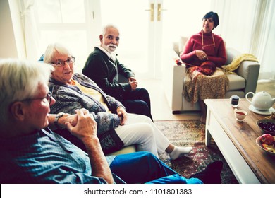 Senior people sitting together in a living room - Powered by Shutterstock