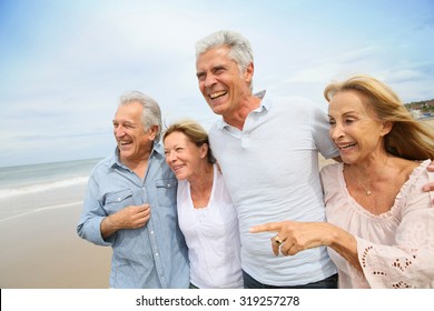 Senior People Walking On The Beach