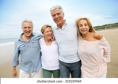 Senior People Walking On The Beach