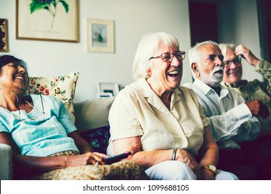 Senior People Watching Television In The Living Room