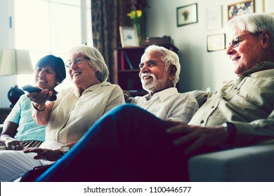 Senior People Watching Television In The Living Room