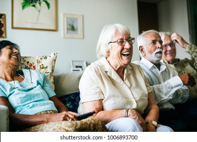 Senior people watching televison together