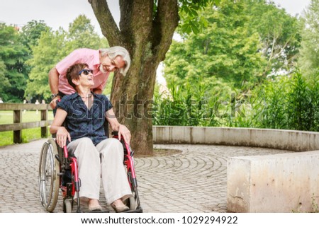 Similar – Granddaughter hugging grandmother in wheelchair