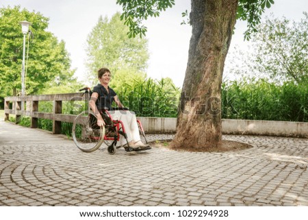 Similar – Granddaughter hugging grandmother in wheelchair