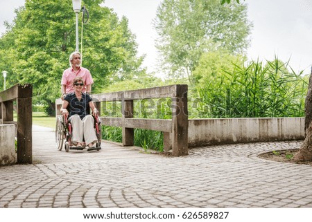 Similar – Granddaughter hugging grandmother in wheelchair