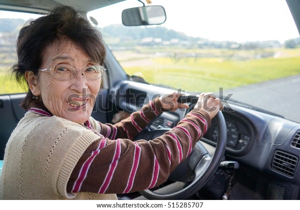 Senior person driving a\
car