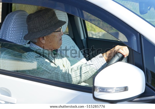Senior person driving a\
car