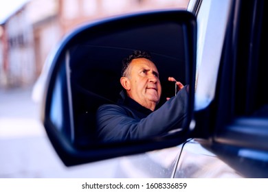 senior person using smartphone in a camper van - Shutterstock ID 1608336859