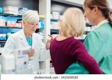 Senior Pharmacist Talking To Mom With Her Kid Explain Effects Of Prescription Drug 