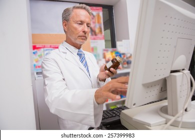 Senior Pharmacist Using The Computer In The Pharmacy