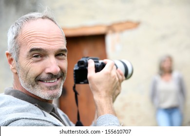 Senior Photographer Using Digital Camera