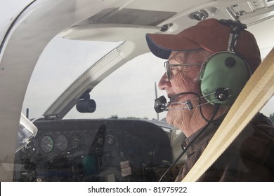 Senior Pilot In The Cockpit Of A Cessna Twin Engine