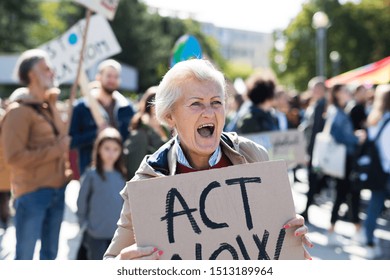 Senior With Placard And Poster On Global Strike For Climate Change, Shouting.