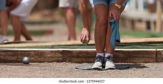 Senior Playing Petanque, Balls On The Ground