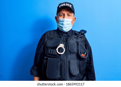 Senior Police Man Wearing Surgical Mask With Serious Expression On Face. Simple And Natural Looking At The Camera. 