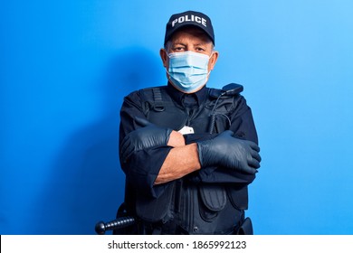 Senior Police Man Wearing Surgical Mask Happy Face Smiling With Crossed Arms Looking At The Camera. Positive Person. 