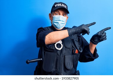 Senior Police Man Wearing Surgical Mask Smiling And Looking At The Camera Pointing With Two Hands And Fingers To The Side. 